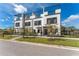 Beautiful townhomes showcasing modern design, black accents, a rooftop terrace, and a well-kept front yard at 6207 64Th N Way, Pinellas Park, FL 33781
