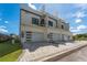 Modern townhome exterior featuring a three-car garage and contemporary design elements at 6207 64Th N Way, Pinellas Park, FL 33781