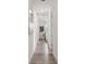 Hallway with wood flooring leading to bedrooms featuring neutral paint and contemporary art at 6207 64Th N Way, Pinellas Park, FL 33781