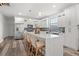 Bright kitchen with an island, quartz countertops, stainless steel appliances, and a stylish blue tile backsplash at 6207 64Th N Way, Pinellas Park, FL 33781