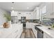 Modern kitchen showcasing white cabinets, granite countertops, and stainless steel appliances at 6207 64Th N Way, Pinellas Park, FL 33781