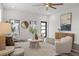 Bright living room featuring modern decor, neutral tones, and plenty of natural light from the large windows at 6207 64Th N Way, Pinellas Park, FL 33781