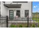 Inviting porch with stylish seating, a decorative fence, and a modern door under a gray awning at 6207 64Th N Way, Pinellas Park, FL 33781