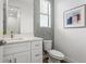 Chic powder room with unique mosaic tiling, modern fixtures, and a stylish framed art piece at 6207 64Th N Way, Pinellas Park, FL 33781