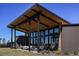Community patio with sleek architectural design offering ample seating and modern hanging chairs at 6224 Timberdale Ave, Wesley Chapel, FL 33545
