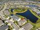 Aerial view showcasing home's location on beautiful lake with mature landscaping at 7328 Paradiso Dr, Apollo Beach, FL 33572