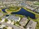 Aerial view of the neighborhood showing homes surrounding a scenic central lake at 7328 Paradiso Dr, Apollo Beach, FL 33572