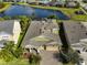 Aerial view of the house with well-maintained landscaping, screened in pool, and stunning water view at 7328 Paradiso Dr, Apollo Beach, FL 33572