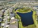 Aerial view showing the neighborhood with lake and surrounding residential area at 7328 Paradiso Dr, Apollo Beach, FL 33572