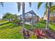 Beautiful backyard view showcasing the screened-in pool and surrounding landscape at 7328 Paradiso Dr, Apollo Beach, FL 33572