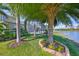 Scenic backyard with a view of the screened-in pool and the tranquil lake beyond at 7328 Paradiso Dr, Apollo Beach, FL 33572