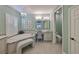 Well-lit bathroom with a soaking tub, vanity area, and tiled floors at 7328 Paradiso Dr, Apollo Beach, FL 33572