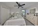 Charming bedroom with a floral-patterned quilt, matching pillows and a ceiling fan at 7328 Paradiso Dr, Apollo Beach, FL 33572
