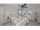 Bedroom with a floral-patterned quilt, matching pillows, ceiling fan and a side table at 7328 Paradiso Dr, Apollo Beach, FL 33572