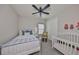 Cozy bedroom featuring a bed, crib, rocking chair, closet, and ceiling fan at 7328 Paradiso Dr, Apollo Beach, FL 33572