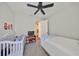 Bedroom features a crib, bed, and view to closet beyond an open door at 7328 Paradiso Dr, Apollo Beach, FL 33572