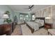 Charming bedroom features a wood accent wall, stylish furniture, and an inviting atmosphere at 7328 Paradiso Dr, Apollo Beach, FL 33572