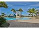 Resort-style community pool area with a tower slide and lounge chairs surrounded by palm trees at 7328 Paradiso Dr, Apollo Beach, FL 33572