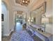 Elegant entryway features wood-look tile flooring, a decorative mirror, and stylish lighting at 7328 Paradiso Dr, Apollo Beach, FL 33572