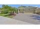 Charming home featuring a three-car garage and a beautifully paved driveway and landscaped front yard at 7328 Paradiso Dr, Apollo Beach, FL 33572