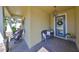 Inviting front porch sitting area offers comfortable seating and shade at 7328 Paradiso Dr, Apollo Beach, FL 33572