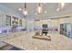 Bright, airy kitchen features granite countertops, stainless steel appliances, and stylish pendant lighting at 7328 Paradiso Dr, Apollo Beach, FL 33572