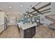 Kitchen with a spacious island and seating, stainless steel appliances, and view of the living and dining area at 7328 Paradiso Dr, Apollo Beach, FL 33572