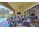 Inviting covered lanai features a stone fireplace and comfortable seating area at 7328 Paradiso Dr, Apollo Beach, FL 33572