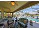 Relaxing covered lanai overlooks a pool and lake, perfect for outdoor lounging at 7328 Paradiso Dr, Apollo Beach, FL 33572