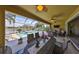 Covered lanai overlooks a beautiful pool with a waterfall feature and lake view at 7328 Paradiso Dr, Apollo Beach, FL 33572