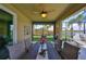 Covered lanai with a dining area is perfect for outdoor entertaining with a lake view at 7328 Paradiso Dr, Apollo Beach, FL 33572