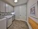 Laundry room with updated cabinets, washer, dryer, and decor at 7328 Paradiso Dr, Apollo Beach, FL 33572