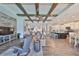 Spacious living room features wood-look tile floors and a decorative wood beam ceiling at 7328 Paradiso Dr, Apollo Beach, FL 33572