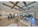 Open-concept living room featuring a coffered ceiling, wood floors, and seamless access to an outdoor living area at 7328 Paradiso Dr, Apollo Beach, FL 33572
