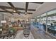 Open-concept living room with a coffered ceiling and views of the kitchen and outdoor pool area at 7328 Paradiso Dr, Apollo Beach, FL 33572