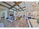 Spacious living room features wood-look tile floors, and a decorative wood beam ceiling at 7328 Paradiso Dr, Apollo Beach, FL 33572
