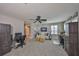 Living room with a white couch, ceiling fan, and desk work space at 7328 Paradiso Dr, Apollo Beach, FL 33572