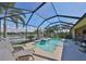 Screened-in pool with a beautiful lake view and comfortable lounge chairs at 7328 Paradiso Dr, Apollo Beach, FL 33572