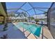 This beautiful screened pool features a spa and lush views of the neighborhood pond at 7328 Paradiso Dr, Apollo Beach, FL 33572