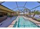 The beautiful pool and spa have lake views and are surrounded by a screened lanai at 7328 Paradiso Dr, Apollo Beach, FL 33572