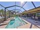 View of the beautiful screened-in pool and the outdoor entertainment area at 7328 Paradiso Dr, Apollo Beach, FL 33572