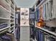 Organized walk-in closet with ample shelving and hanging space for clothing and accessories at 7328 Paradiso Dr, Apollo Beach, FL 33572