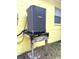 A modern A/C unit mounted on a raised wooden platform outside the property at 7411 S Elliott St, Tampa, FL 33616