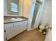 Bathroom featuring a walk-in shower with a vanity and sink at 7411 S Elliott St, Tampa, FL 33616