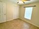 Bedroom featuring tile flooring, a ceiling fan, and a closet at 7411 S Elliott St, Tampa, FL 33616