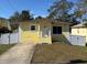 Charming yellow home with a well-manicured lawn and freshly painted white trim at 7411 S Elliott St, Tampa, FL 33616