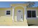 Inviting front entrance featuring an arched portico supported by classic white columns at 7411 S Elliott St, Tampa, FL 33616