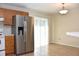 Kitchen area with a large stainless steel fridge and access to a sliding glass door to the outside at 7411 S Elliott St, Tampa, FL 33616