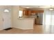Open-concept kitchen featuring stainless steel appliances and a breakfast bar area at 7411 S Elliott St, Tampa, FL 33616