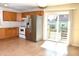 A well-lit kitchen featuring stainless steel appliances and sliding glass doors leading to the deck at 7411 S Elliott St, Tampa, FL 33616